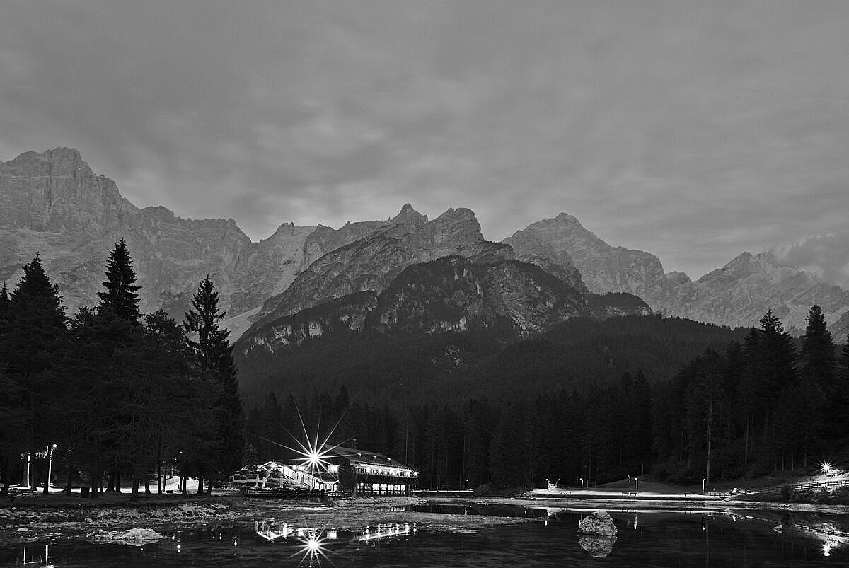Evening in San Vito di Cadore in the Dolomites with the mountains reflected in a lake