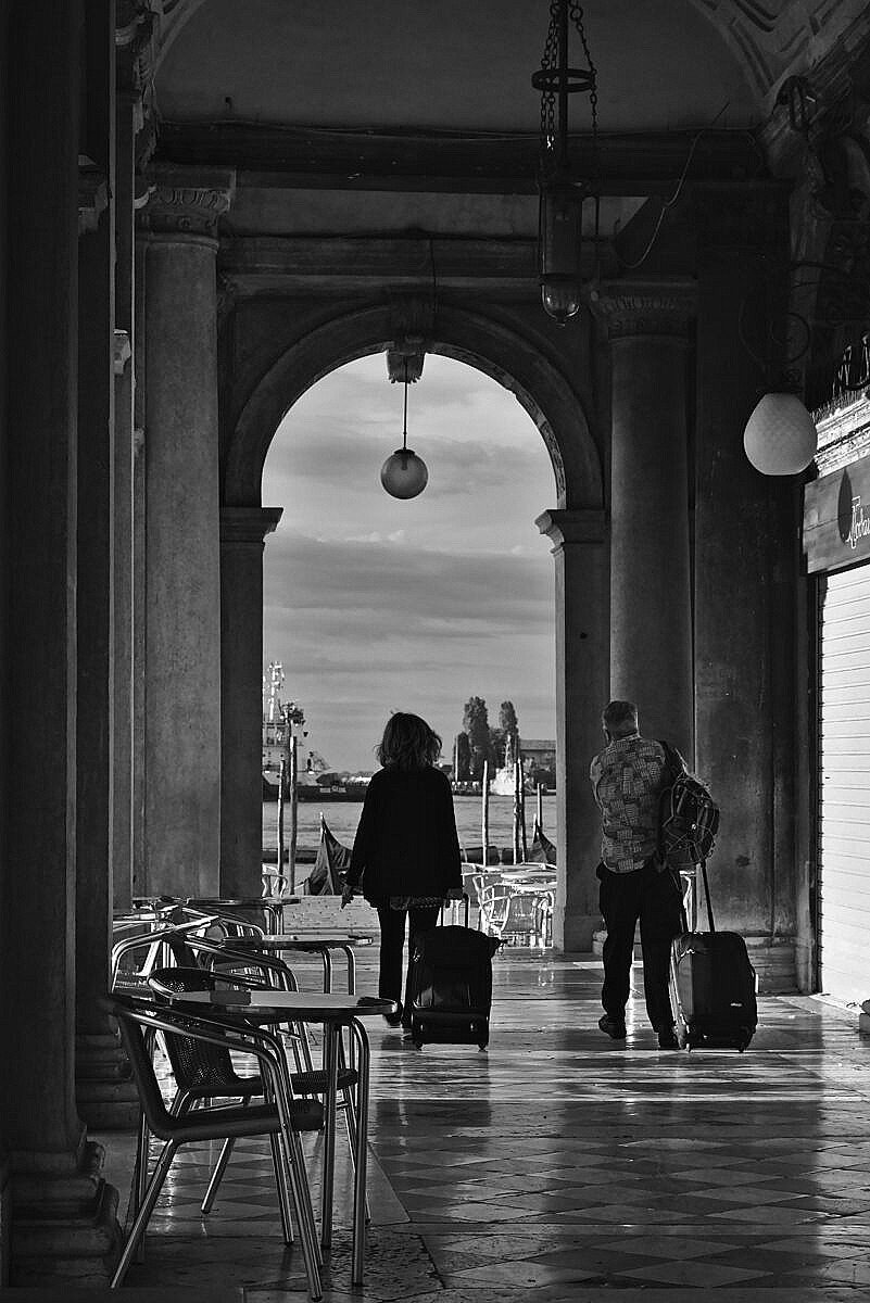 Early morning at St. Mark's, tourists heading home with their luggage