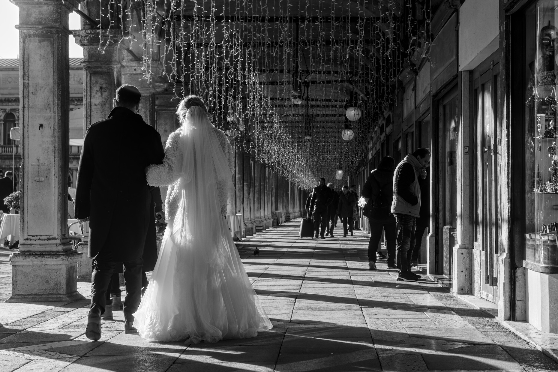 Couple of newlyweds walking under the procuratie in St. Mark's square