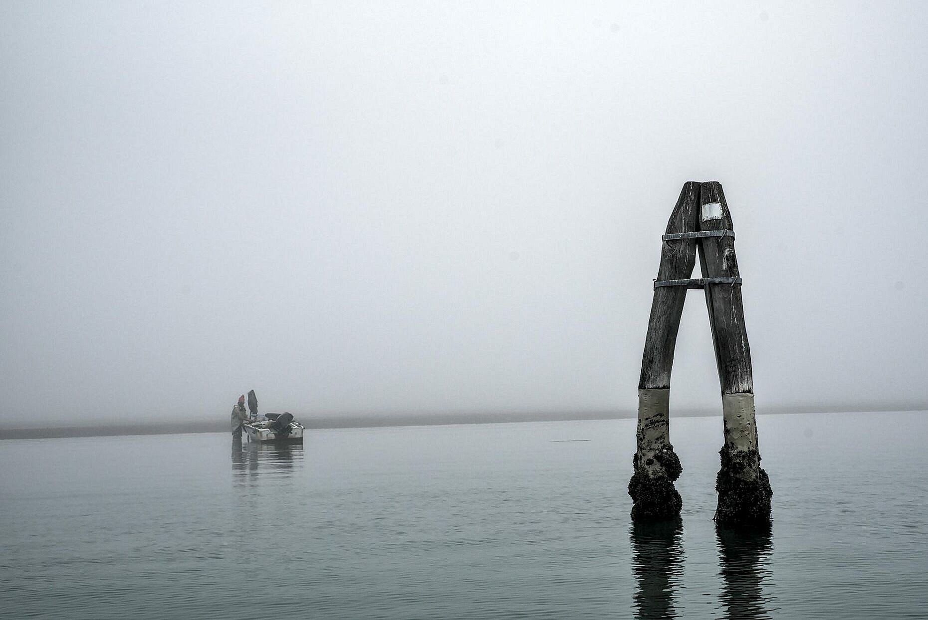 The Venetian lagoon on the fog - fisherman