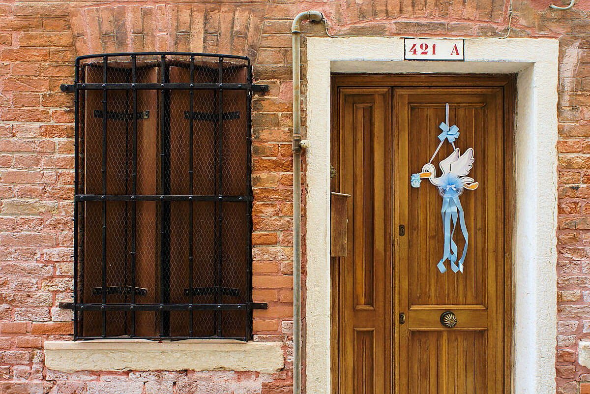 Venetian doorway with a decoration showing that a boy has been born to the people living there.