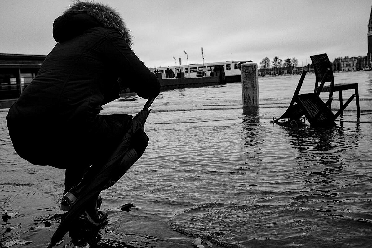High tide - Venice under water - photographer at work